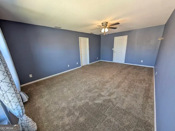 a bedroom with a bed and flat screen tv