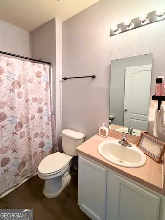 a bathroom with a sink toilet and mirror