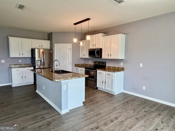 a room with furniture and wooden floor