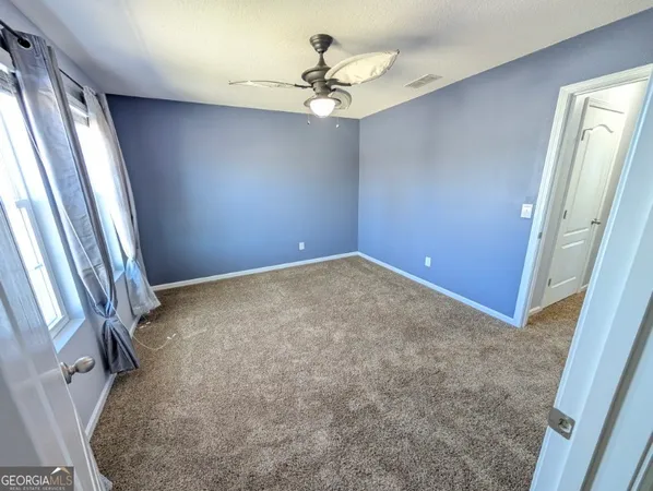 a bedroom with a bed dresser and a window
