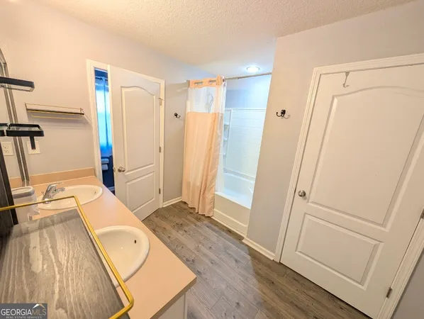 a bathroom with a toilet and a shower curtain