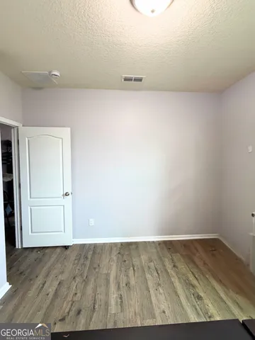 an empty room with wooden floor