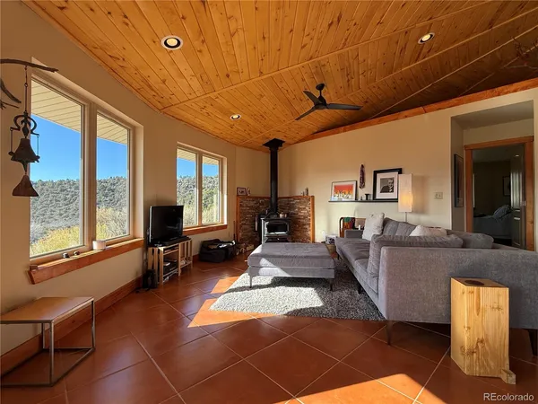 a spacious bedroom with a bed and wooden floor