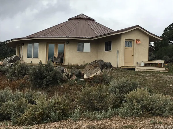 a kitchen with cabinets and chairs