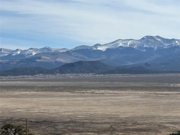 a view of a mountain with an ocean beach