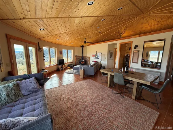 a spacious bedroom with a bed and wooden floor