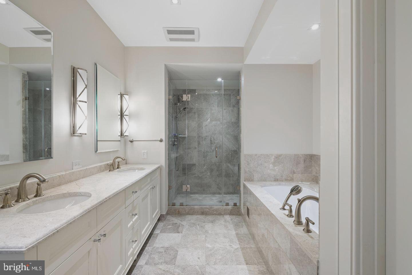 130 South 18th Street, Unit 2801 Philadelphia, PA 19103 - Photo 19 of 51 a bathroom with a tub sink and mirror