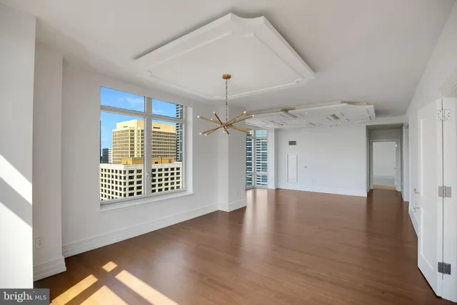 a bathroom with a granite countertop shower a mirror and vanity