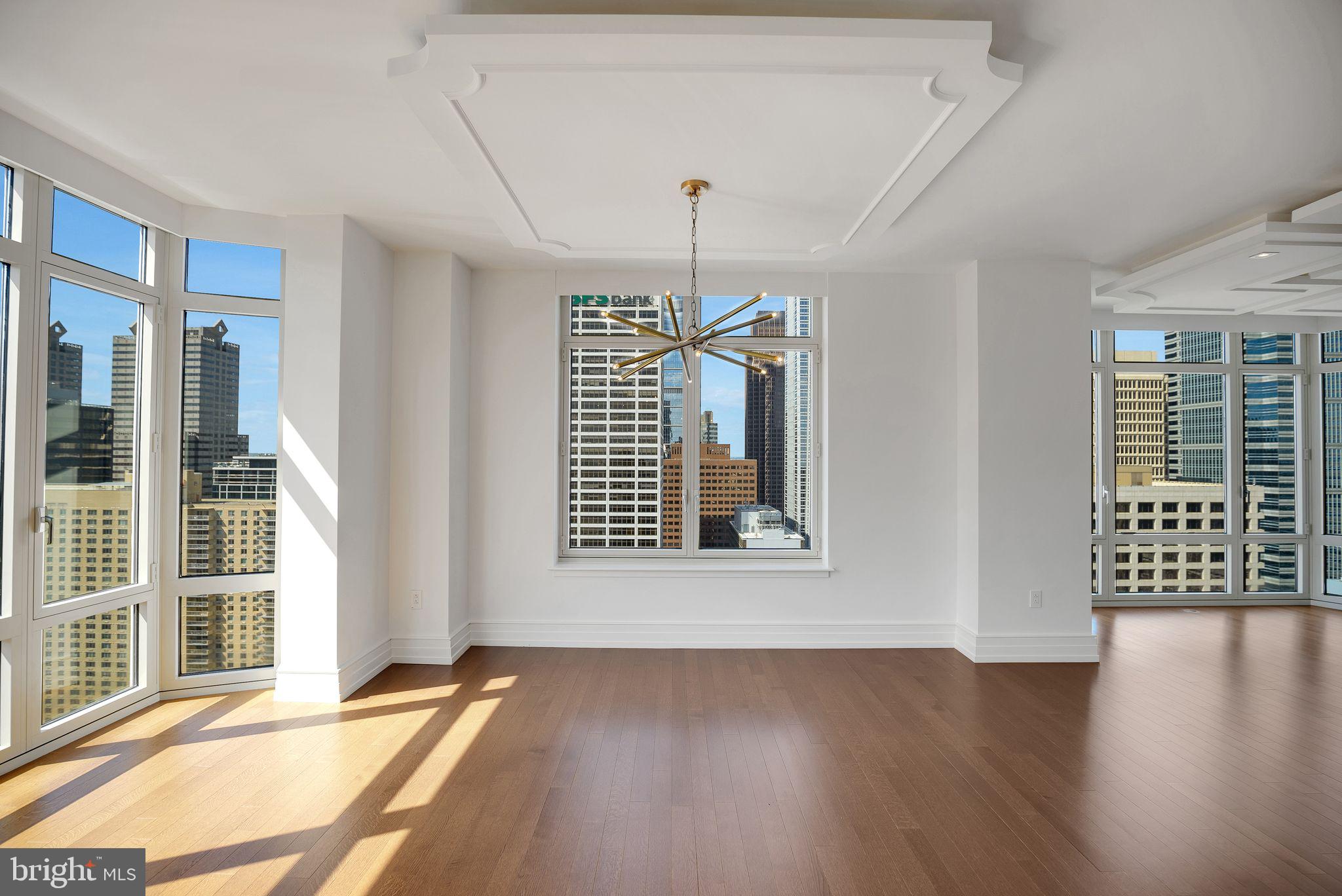 130 South 18th Street, Unit 2801 Philadelphia, PA 19103 - Photo 29 of 51 a view of an empty room with wooden floor and a window