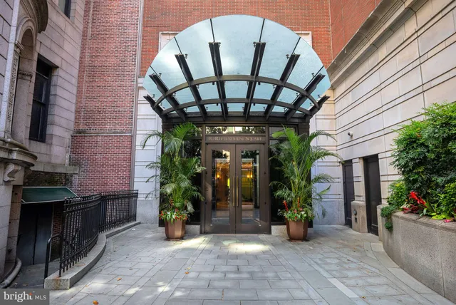 a dining room with furniture potted plants and wooden floor