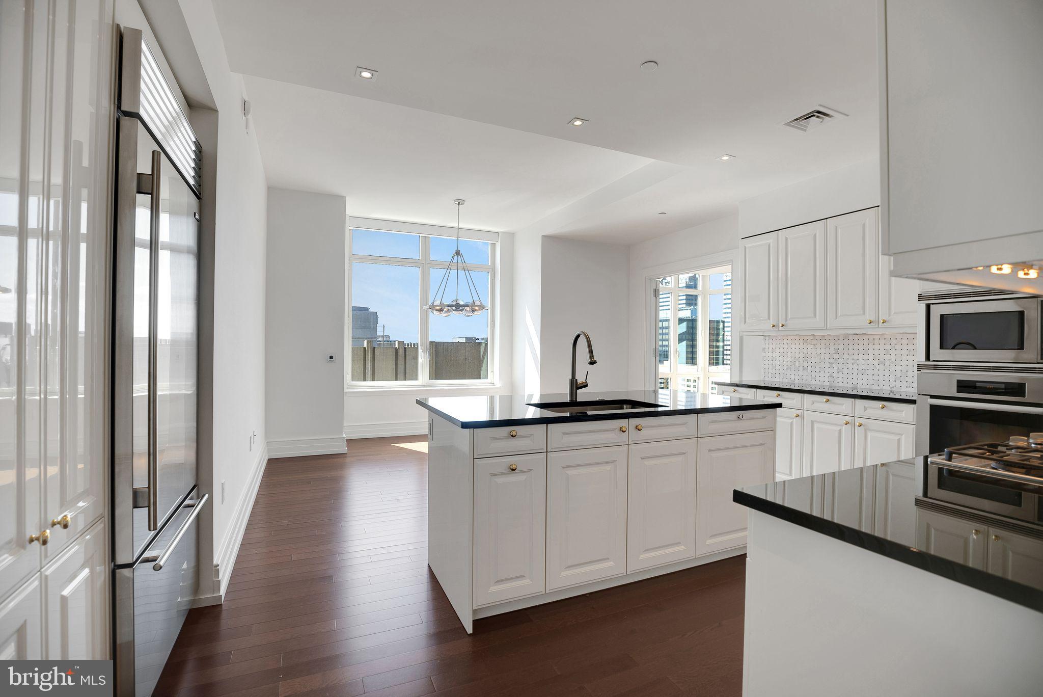 130 South 18th Street, Unit 2801 Philadelphia, PA 19103 - Photo 35 of 51 a kitchen with stainless steel appliances granite countertop a stove a sink and a refrigerator