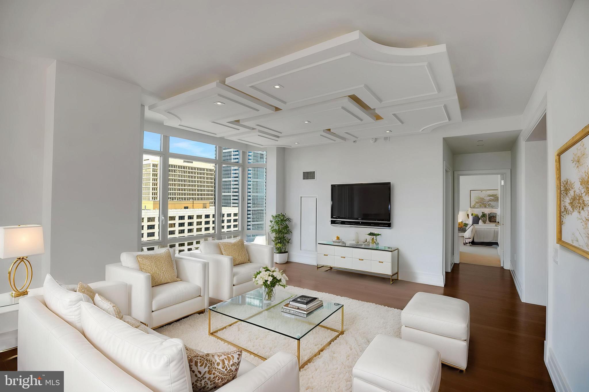 130 South 18th Street, Unit 2801 Philadelphia, PA 19103 - Photo 8 of 51 a living room with furniture and a flat screen tv