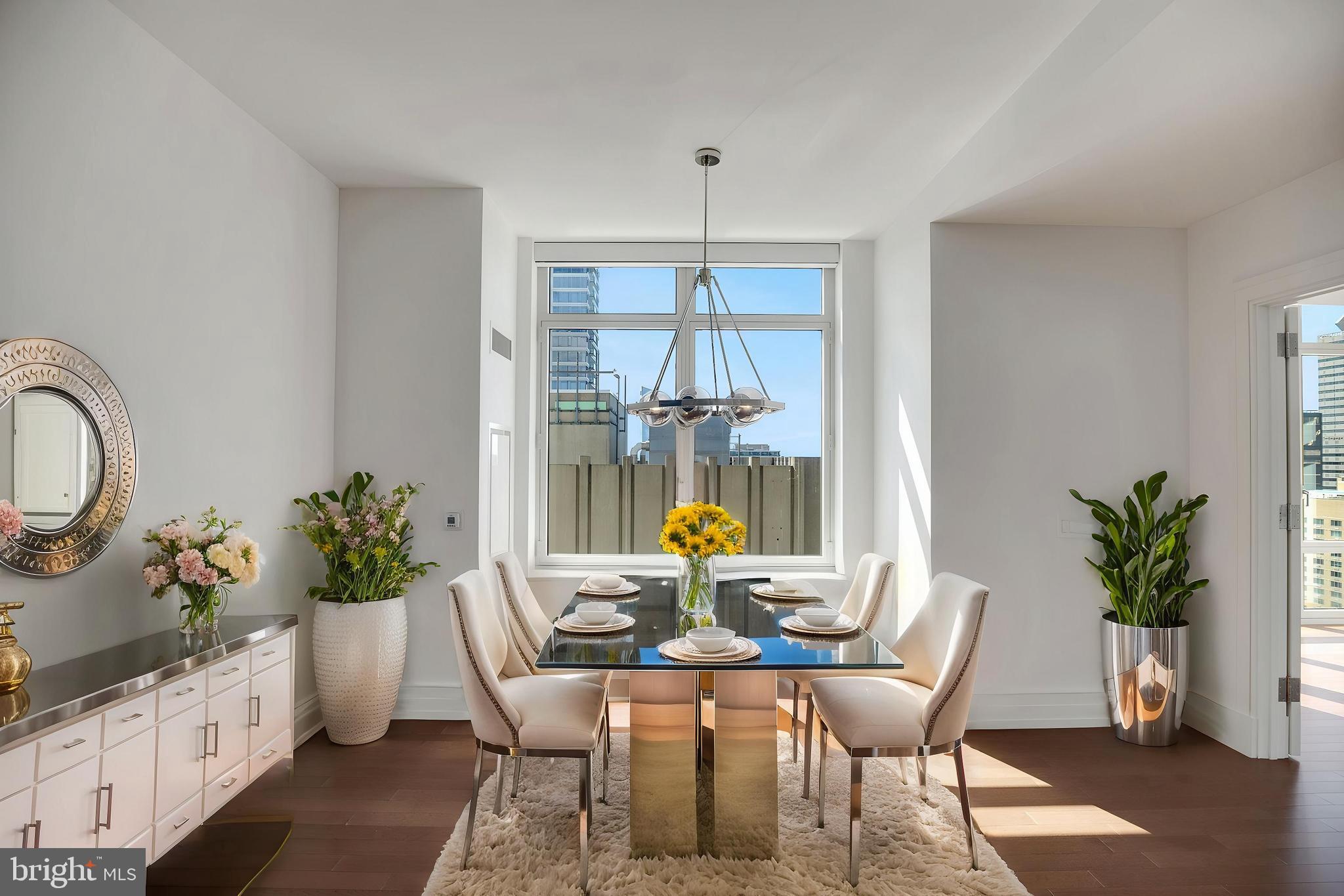 130 South 18th Street, Unit 2801 Philadelphia, PA 19103 - Photo 10 of 51 a dining room with furniture potted plants and wooden floor