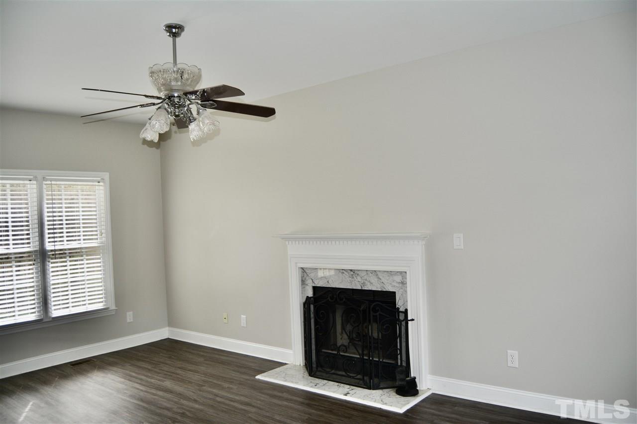 1625 Martin Pond Road Wendell, NC 27591 - Photo 5 of 30 Family room with wood burning fireplace, open from front to back, with lots of natural light.