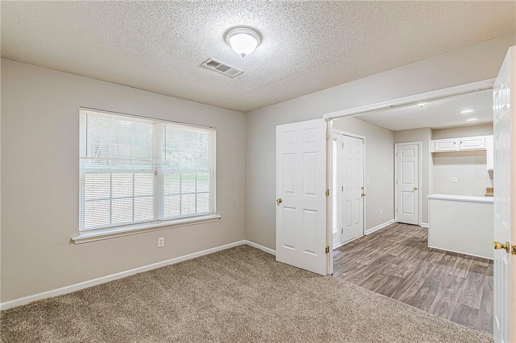5850 Sable Glen Road Atlanta, GA 30349 - Photo 16 of 33 an empty room with windows and closet
