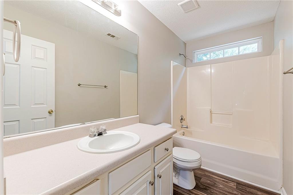 5850 Sable Glen Road Atlanta, GA 30349 - Photo 26 of 33 a bathroom with a sink a toilet and shower