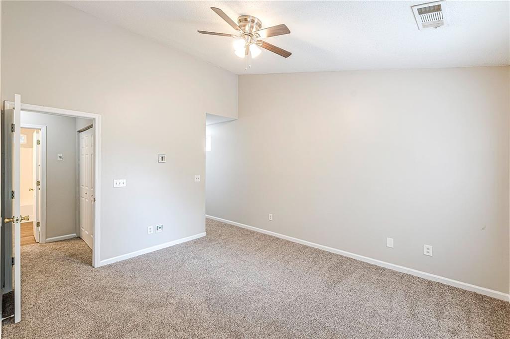 5850 Sable Glen Road Atlanta, GA 30349 - Photo 30 of 33 an empty room with a ceiling fan and a window