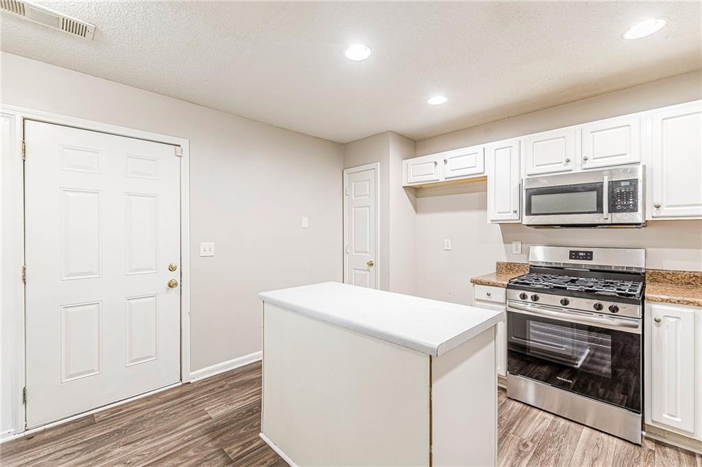 5850 Sable Glen Road Atlanta, GA 30349 - Photo 7 of 33 a kitchen with a stove and a microwave