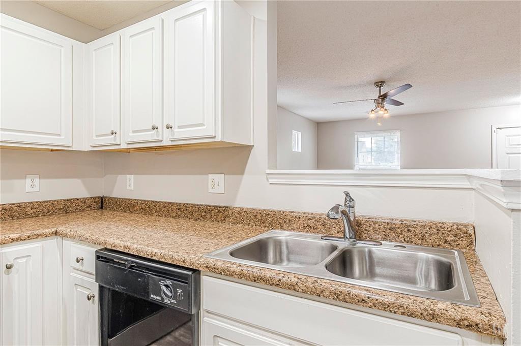5850 Sable Glen Road Atlanta, GA 30349 - Photo 8 of 33 a kitchen with granite countertop a sink and cabinets