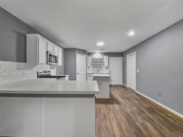 a view of kitchen with wooden floor and window