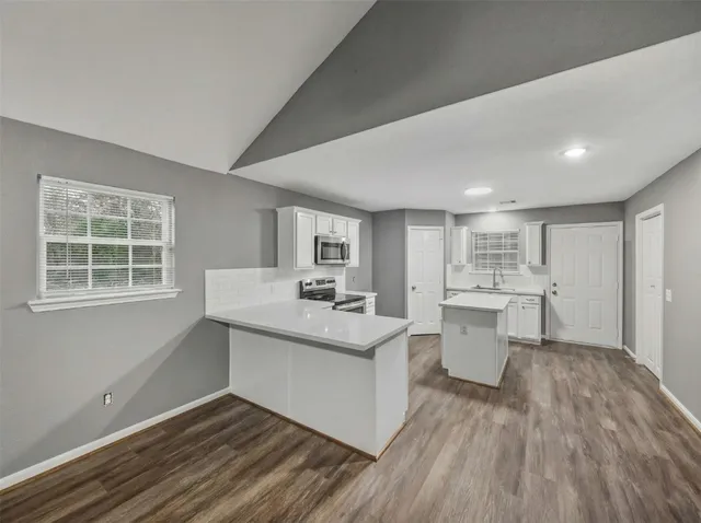 a view of kitchen with sink microwave and refrigerator
