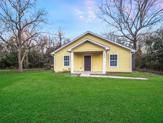 a front view of house with yard and green space
