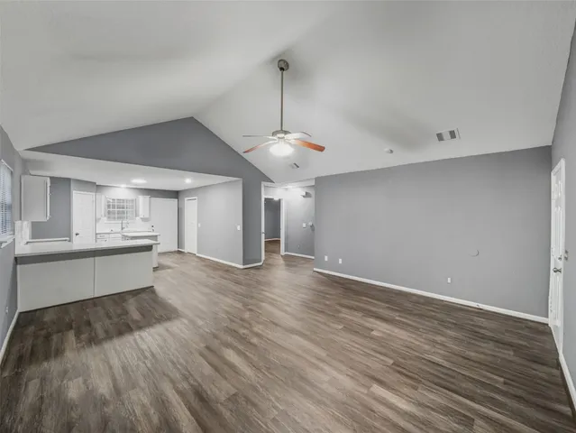 a view of a kitchen with wooden floor and a sink