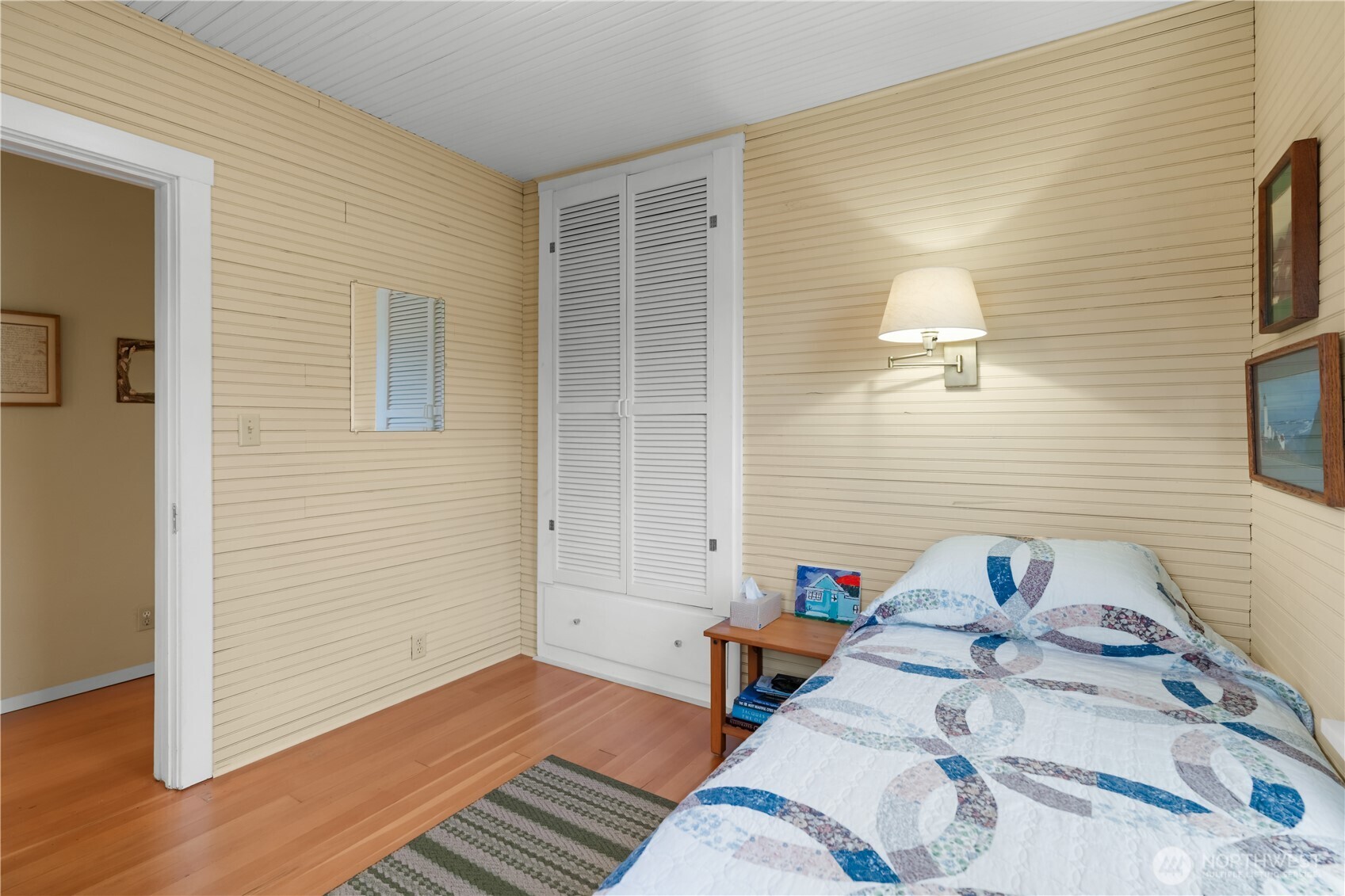 212 2nd Street Northeast Long Beach, WA 98631 - Photo 18 of 33 a bedroom with a bed and wooden floor