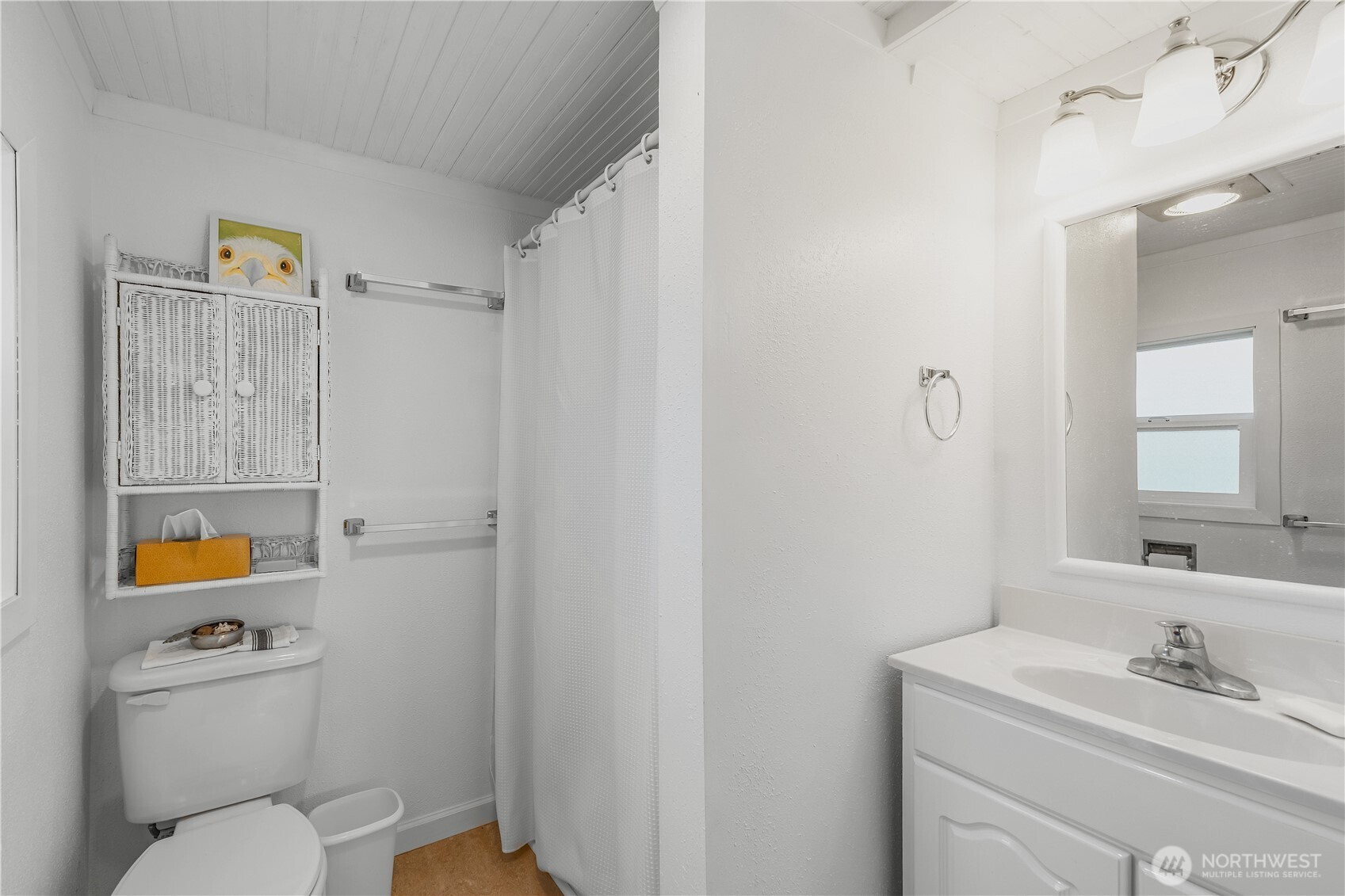 212 2nd Street Northeast Long Beach, WA 98631 - Photo 20 of 33 a bathroom with a toilet sink vanity and mirror