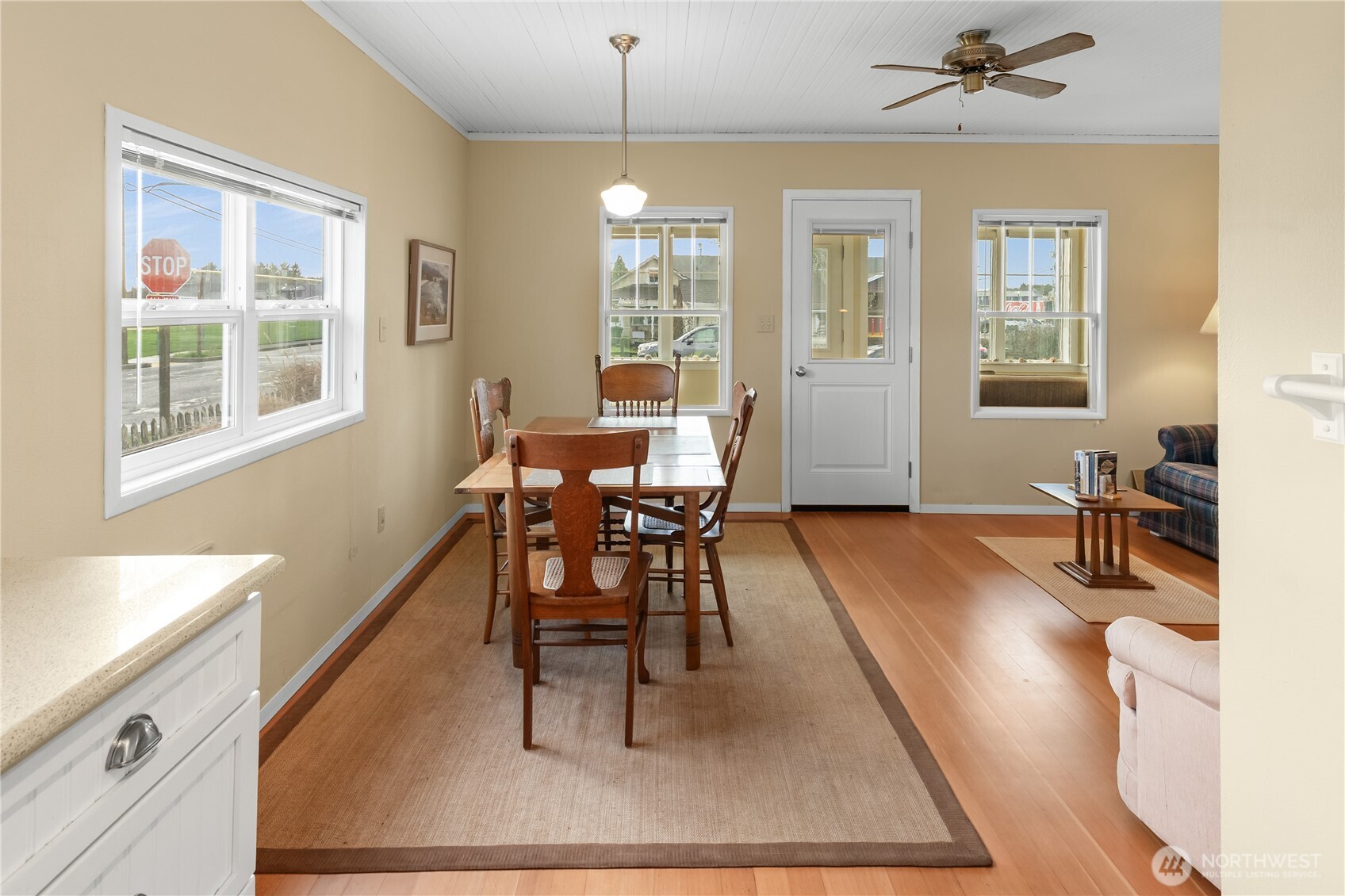 212 2nd Street Northeast Long Beach, WA 98631 - Photo 8 of 33 a dining room with wooden floor and a chandelier