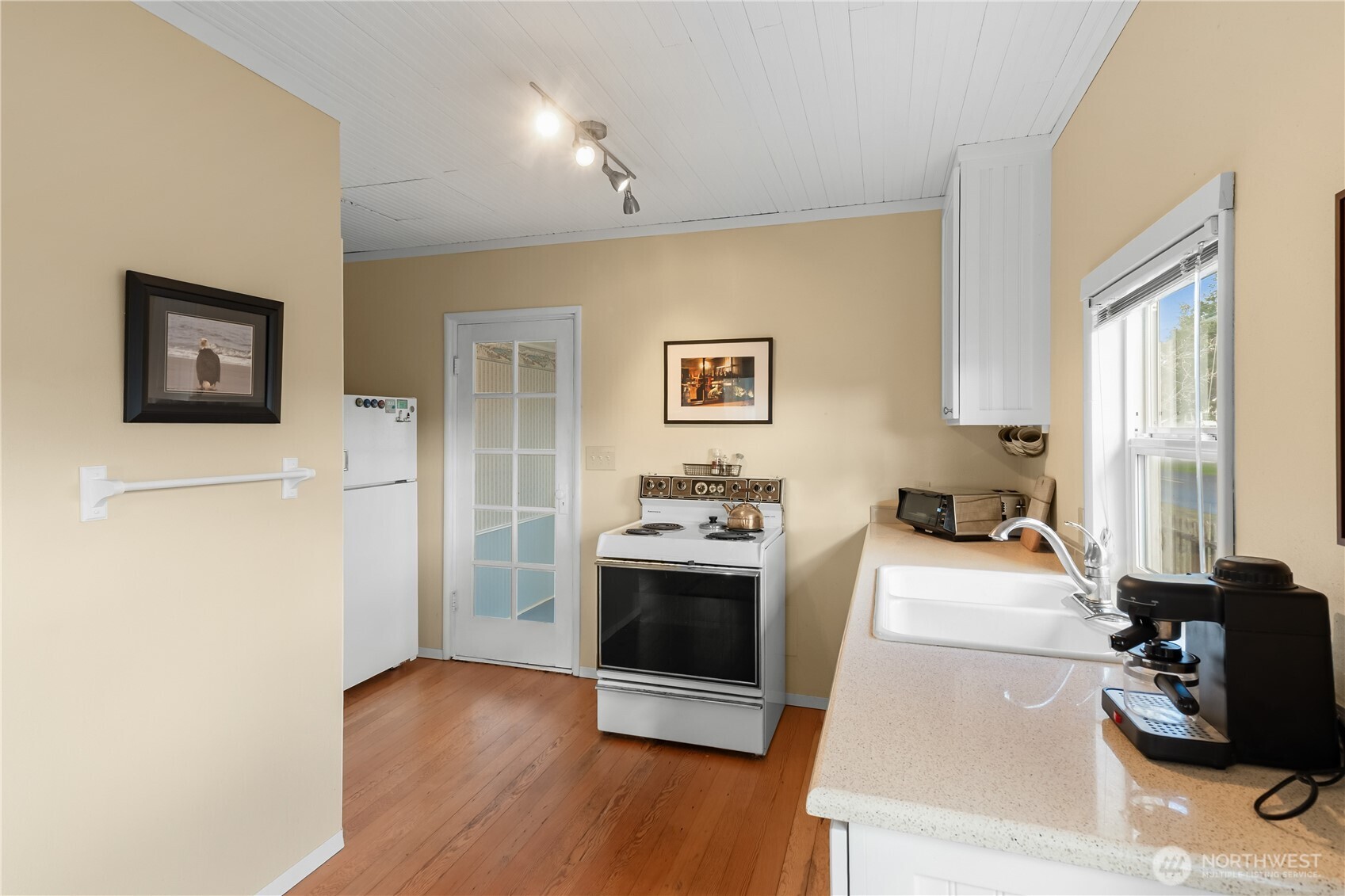 212 2nd Street Northeast Long Beach, WA 98631 - Photo 9 of 33 a view of a kitchen with stainless steel appliances wooden floor and a window