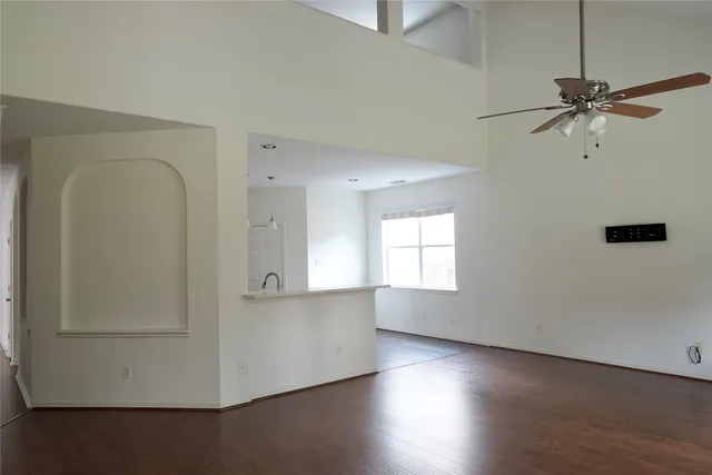 wooden floor in an empty room with a window