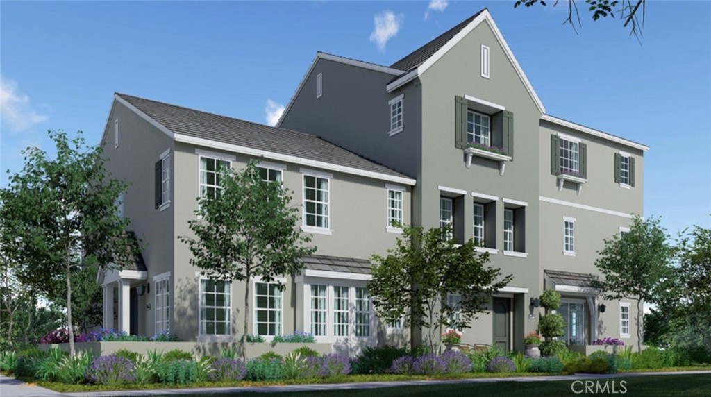 a front view of a house with plants and garden