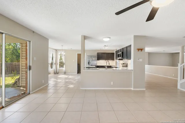 a kitchen with stainless steel appliances granite countertop a refrigerator sink and cabinets