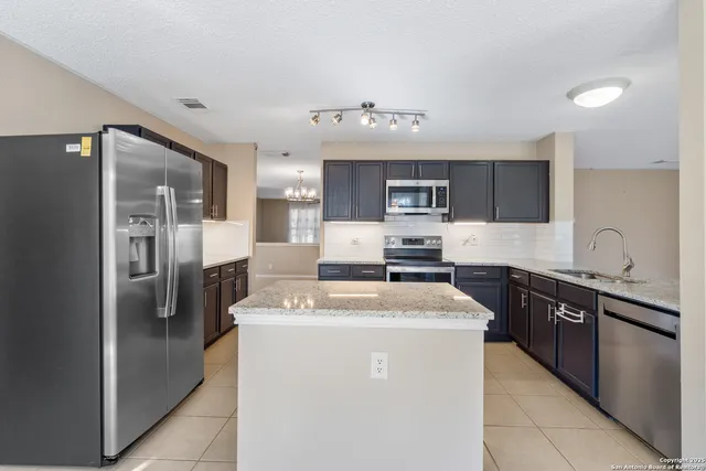 a sink with granite countertop a sink and cabinets