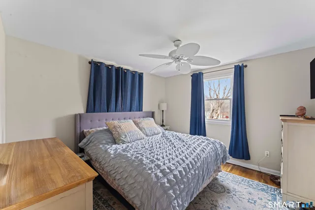 a bedroom with a large bed and a chandelier