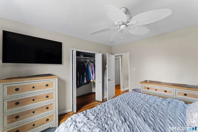 a bedroom with a bed and a flat tv screen in it