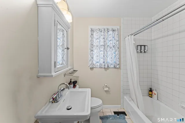 a bathroom with a sink a toilet and a bathtub