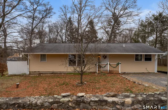 a white house that has tree in front of it