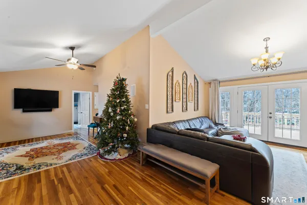 a bedroom with a bed window and a flat screen tv