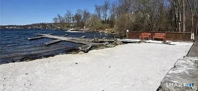 a view of a backyard with wooden fence