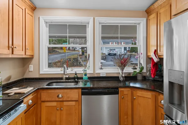 a kitchen with stainless steel appliances granite countertop a refrigerator and a sink