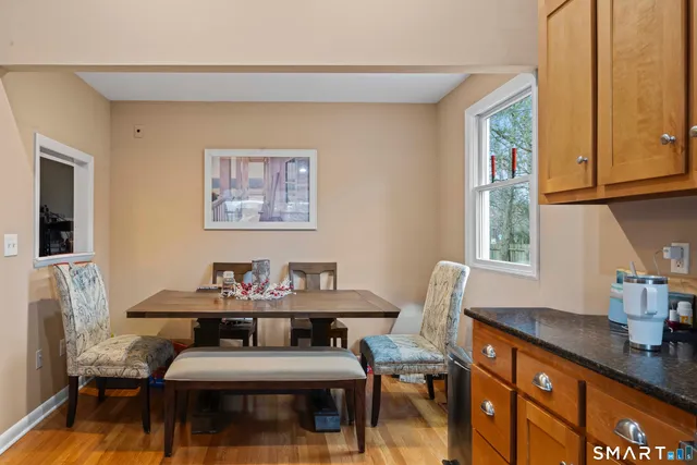 a view of a workspace with furniture and window