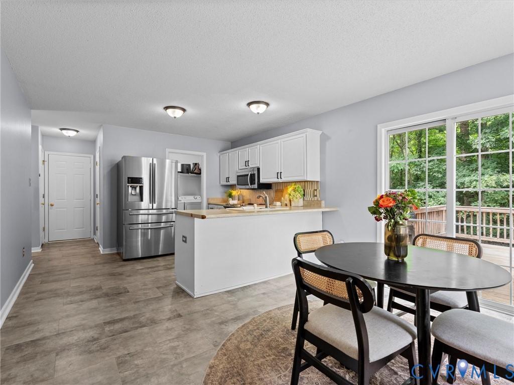 6712 Hedges Road Richmond, VA 23224 - Photo 26 of 34 Bright kitchen with white cabinetry, stainless ste