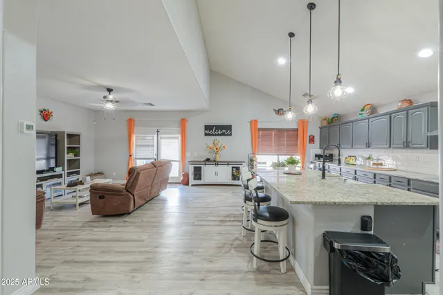 a kitchen with stainless steel appliances kitchen island granite countertop a sink and cabinets
