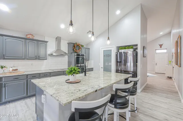 a living room with furniture a flat screen tv and a window
