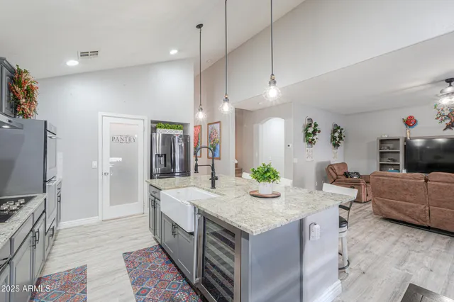 a living room with furniture kitchen view and a table