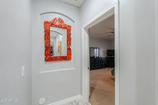 a view of staircase with lots of frames on wall and a window