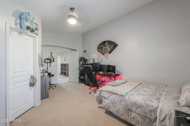a bedroom with furniture and a book shelf