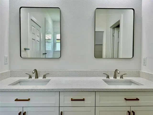 a bathroom with sink mirror and